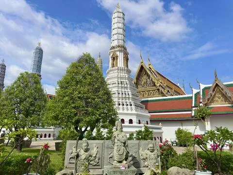 Ancient stone warrior statues standing guard in front of historic stupas with Stock Photos