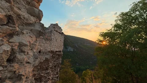Ancient stones frame a golden sunset over distant hills. Soko Grad, Serbia 動画素材 345897158