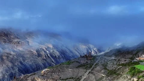 Ancient Structures Nestled Among Misty Mountain Peaks in Tibet China Stock Footage 346737257