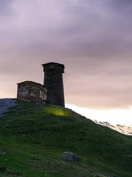 Ancient Svan tower and stone building at dusk in Ushguli, Svaneti, Georgia. Stock Photos