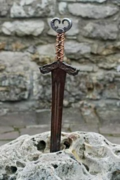 Ancient sword stuck in stone Stock Photos
