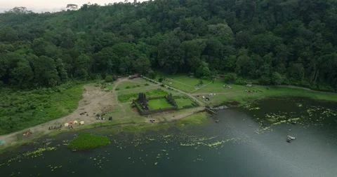 Ancient temple in Bali nestled amidst a lush landscape of greenery mountains Stock Footage 276517048
