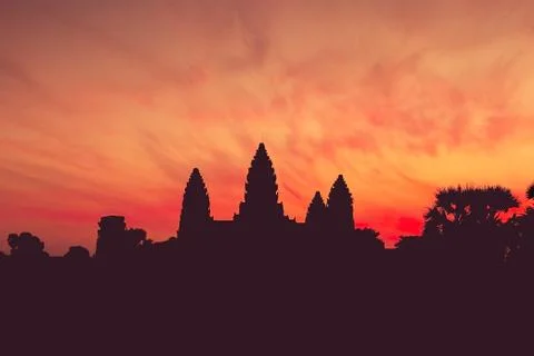 Ancient temple complex Angkor Wat at dawn, silhouette. Toning. Stock Photos