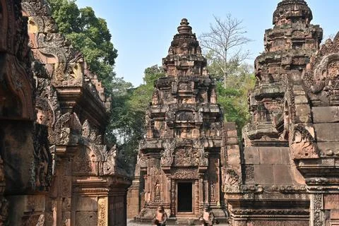 Ancient temple complex with richly decorated stone towers and carvings Stock Photos