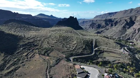 Ancient Terraced Plantations Surrounded by Dramatic Mountains and Village Stock Footage 309880437
