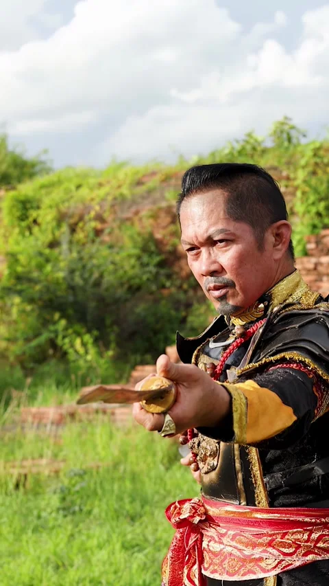 Ancient Thai Warrior in Traditional Armor Training with Dual Swords Stock Footage 338319668