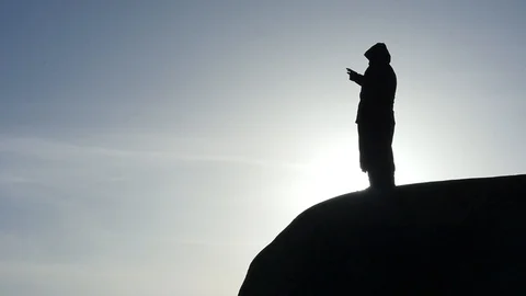 Ancient times man at the edge of cliff silhouette Stock Footage 103690953