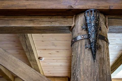 Ancient torch. Wooden interior. Elements of decor in the old style. Stock Photos