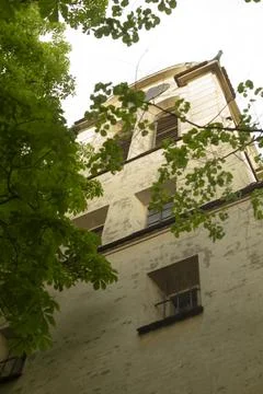 Ancient tower hides secrets. Massive structure amid lush foliage Stock Photos