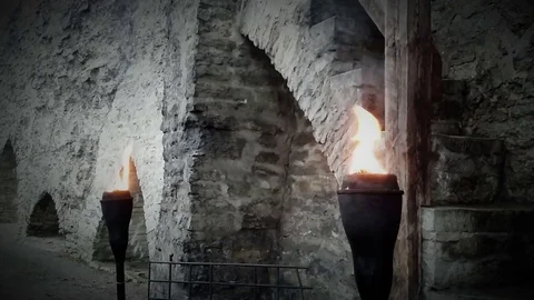 Ancient tower wall highlighted by pair of iron torch. Stock Footage 70465392