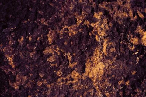 Ancient violet granite stone surface of cave for interior 库存照片