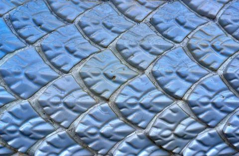 The ancient wall, blue, glazed tile roof, located in the temple  in thai Stock Photos