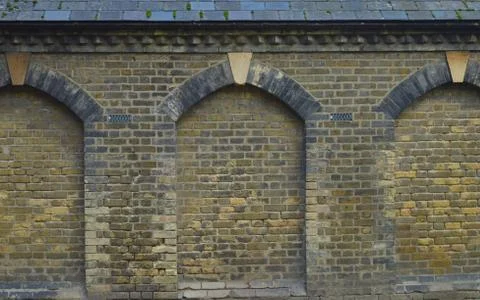 Ancient wall of a cemetry with pattern of a doorway forming a pattern 写真素材