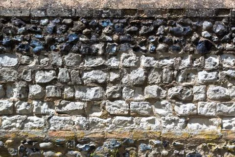 Ancient wall made of different kind of stone Stock Photos
