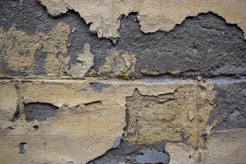 Ancient wall with peeling plaster. Old concrete wall, panoramic textured Stock Photos