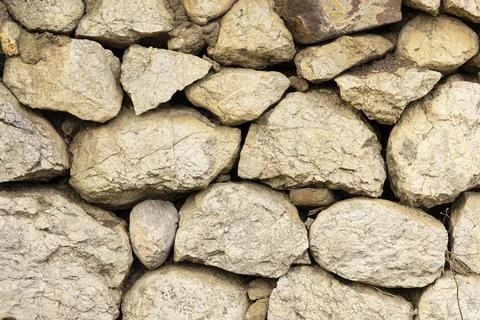 An ancient wall of stacked stone. background Stock Photos