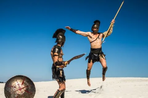 An ancient warrior with a spear in a jump attacks the Spartan Stock-Fotos