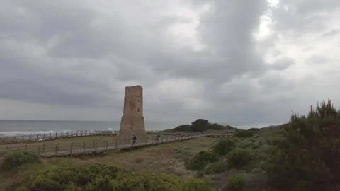 Ancient watchtower called Torre Ladrones in the dunes of Artola, Marbella. Stock Footage 287988906