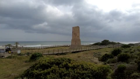 Ancient watchtower called Torre Ladrones in the dunes of Artola, Marbella. Stock Footage 287988927