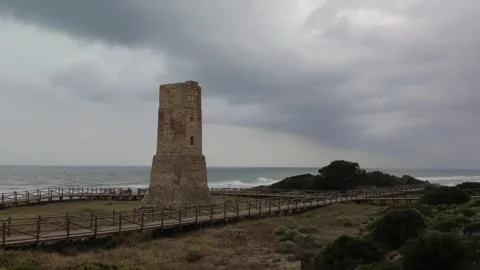 Ancient watchtower called Torre Ladrones in the dunes of Artola, Marbella. Stock Footage 287988947