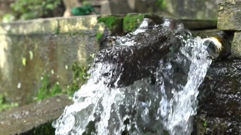 Ancient water source through rock and statue. Stock Footage 226300789