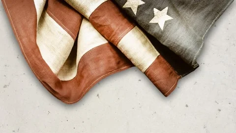 Ancient weathered American flag in front of a concrete wall Stock Footage 154945106