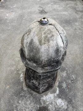 Ancient Weathered Stone Post &amp; Decorative Dome Artifact on Concrete Ground Stock Photos