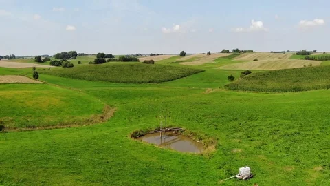 An ancient wind pump above an artificial lake. Stock Footage 114383060