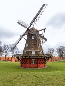 Ancient windmill from the main wooden structure and the base of red color Stock Photos