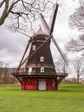 Ancient windmill from the main wooden structure and the base of red color Stock Photos