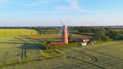 Ancient windmill stands tall amid golden fields 스톡 동영상 342614915