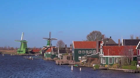 Ancient windmills at the Zaan river against a blue sky in sunny weather 4k Stock Footage 269014556