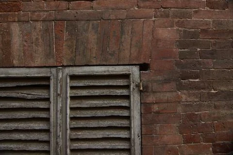  ancient window in red block wall 写真素材