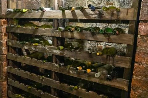 Ancient wine rack with empty bottles of wine Фото