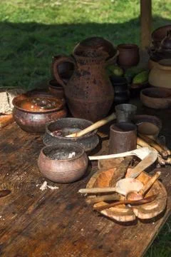 Ancient wooden and clay dishes left on table after dinner Stock Photos