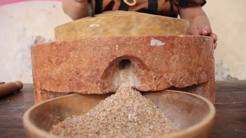 Ancient works. hand turns stone grinder3 Stock Footage 126091453