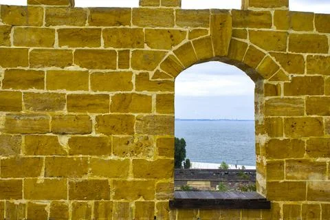 Ancient yellow brick tower wall Stock Photos