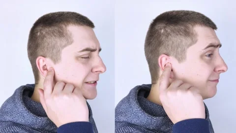 Before and after. On the left, the man indicates ear pain, and on the right, ind Stock Footage 150566039