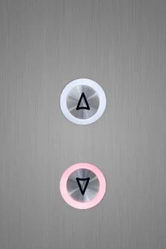 Up and down elevator buttons with down button lit up Foto stock