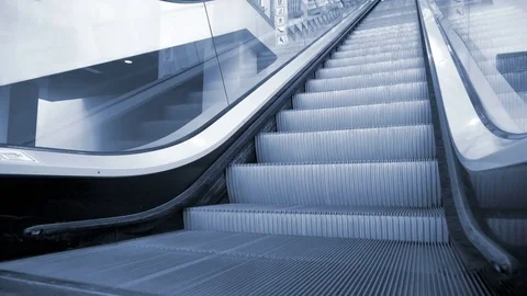 Up and down escalators in public building. Blue tone Stock Footage