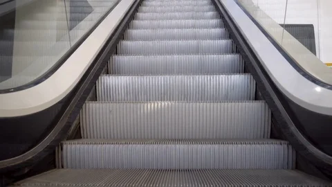 Up and down escalators in public building Stock Footage