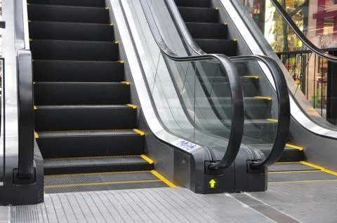 Up and down escalators in public building. Stock Photos