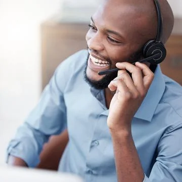 And just like that, problem solved. a handsome young male call center agent Stock Photos