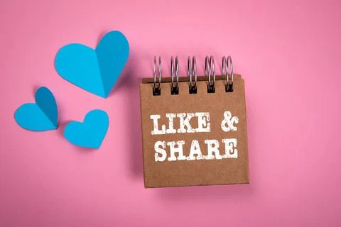 Like and Share concept. Notebook on pink background Stock Photos
