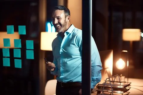 And thats why I stayed late. a mature businessman having a brainstorming session Stock Photos