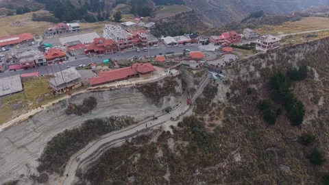 Andean town Quilotoa perched dramatically, winding road threading through 스톡 동영상 308397402