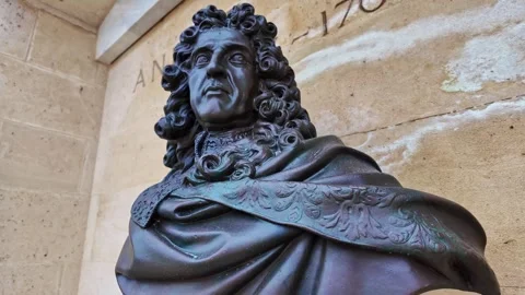 Andre Le Notre bronze bust of a historical figure set against a stone wall in Stock Footage 306915324
