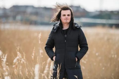 Androgenic man between reed in residential area Stock Photos