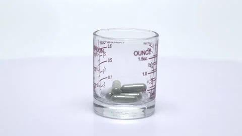 Andrographis paniculata capsules in glass Stock Footage 161339807