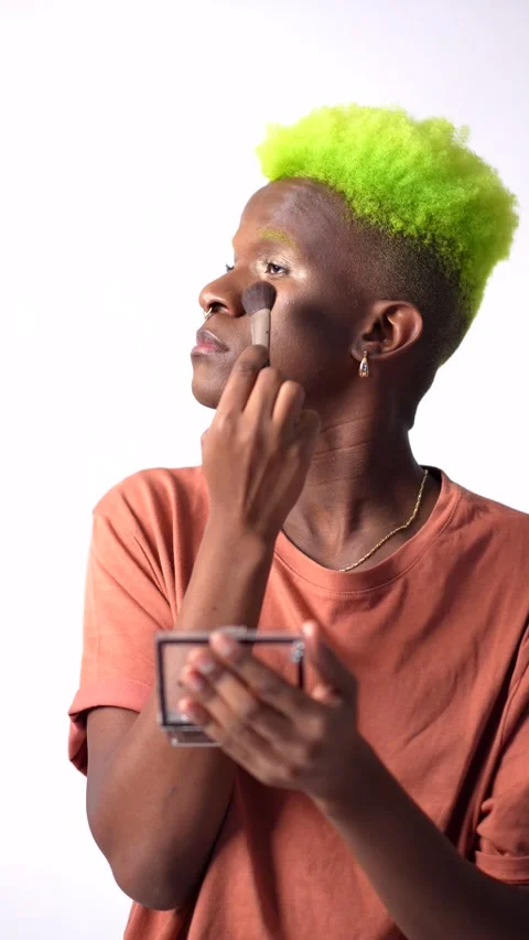 An androgynous black man posing putting on makeup, LGTBI Stock Footage 219304359
